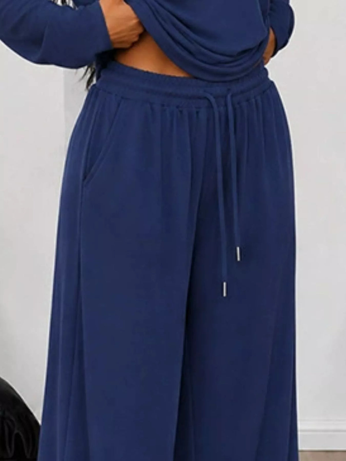 Plus size one-shoulder top and drawstring pants matching set by Trendsi, stylish and comfortable full-size outfit.