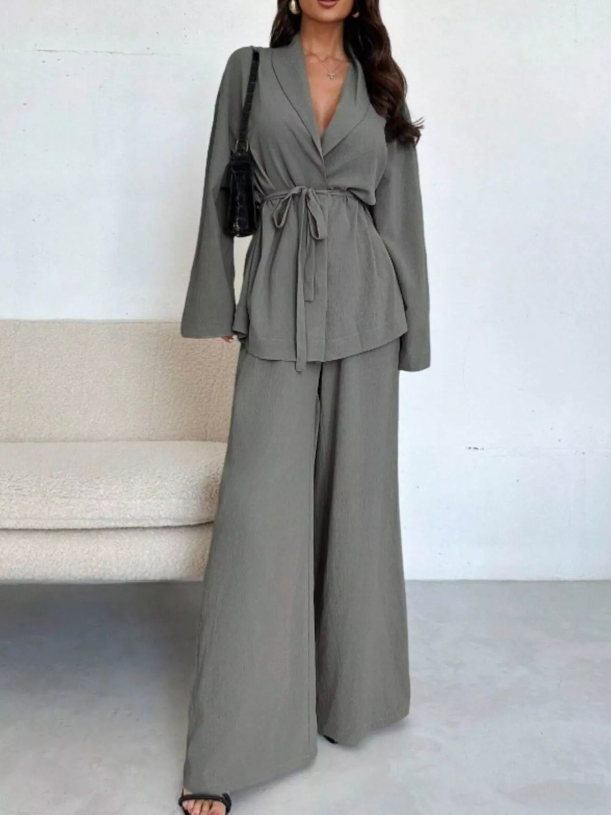 Textured tie waist top and wide-leg pants set for women by Trendsi, featuring stylish, comfortable design and high-quality fabric.