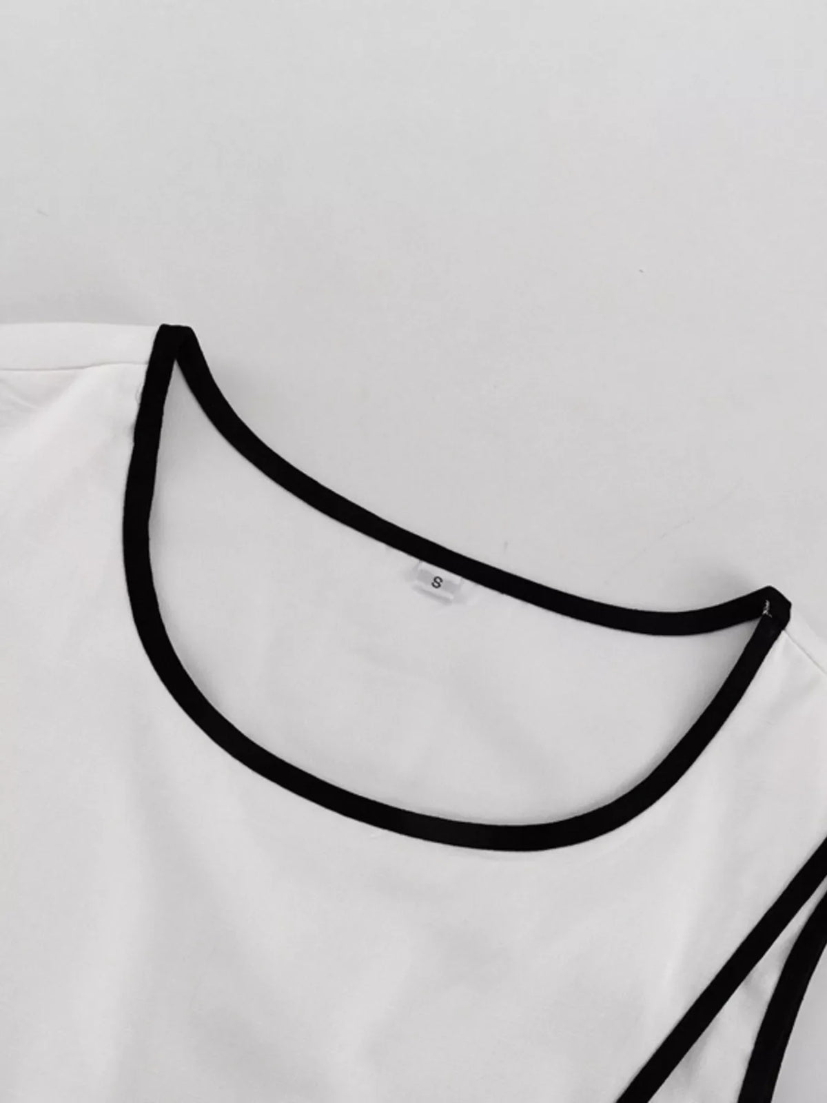 Contrast trim sleeveless top and wide-leg pants set from Plush Fashion Hub, styled together in a modern two-piece ensemble.