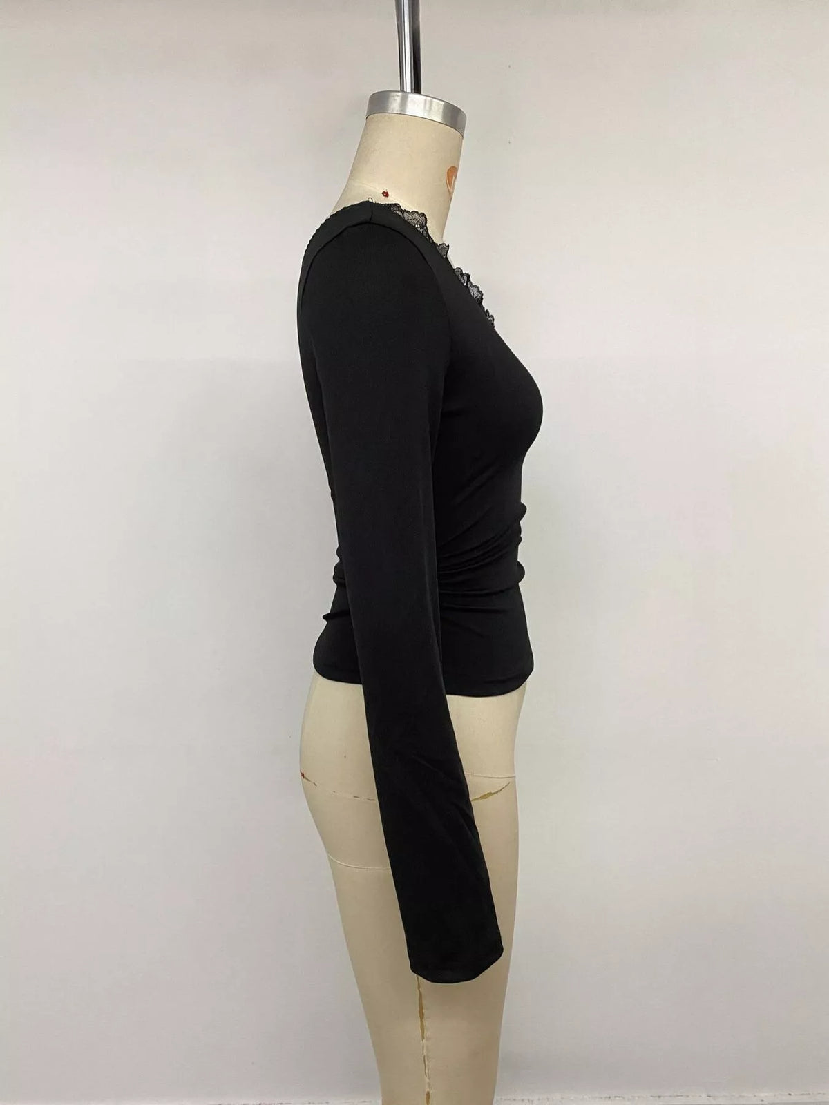 One-shoulder slim fit T-shirt with lace trim from Trendsi, featuring a stylish design and fitted silhouette.