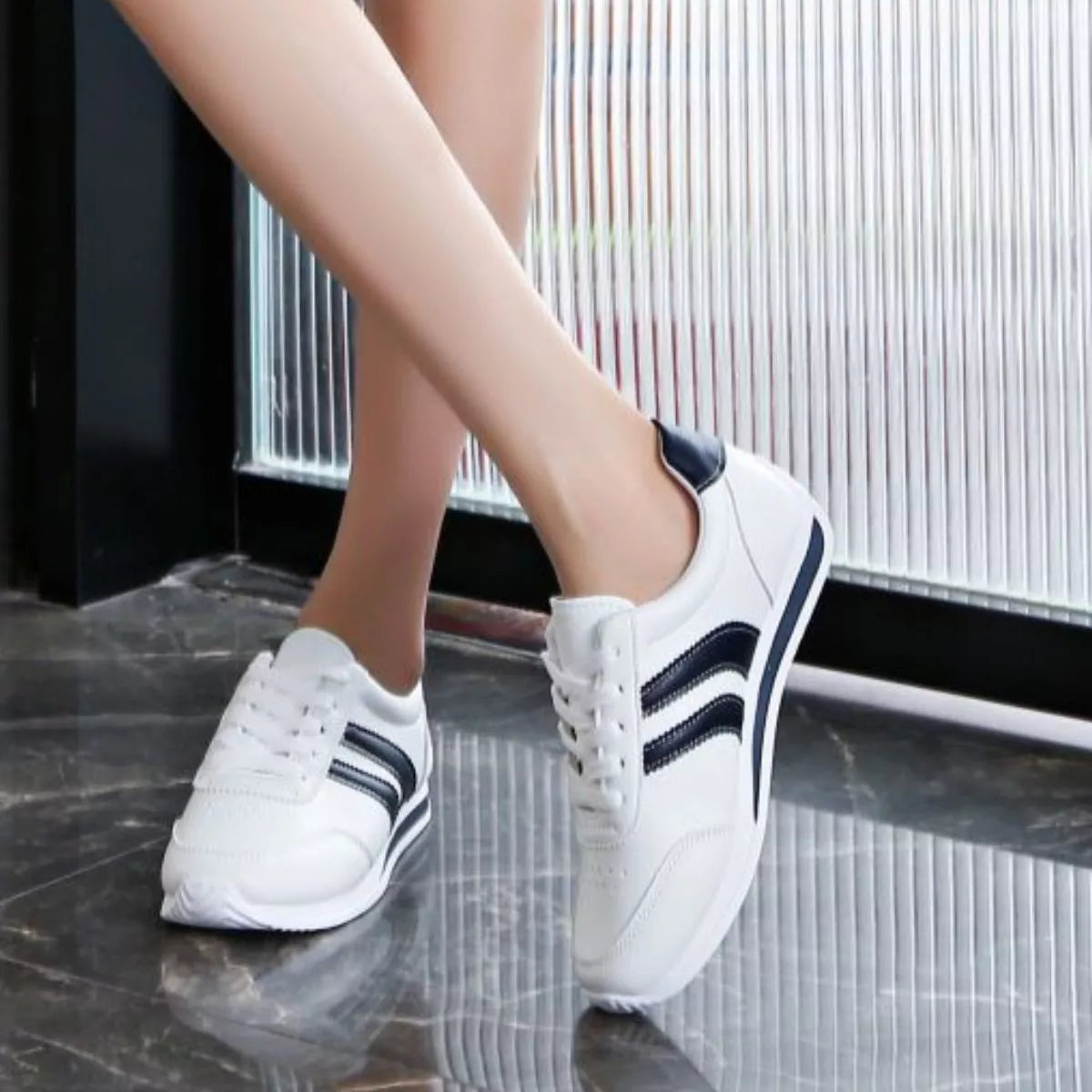 Women’s classic striped sneakers by Trendsi, featuring a stylish design with colorful stripes on comfortable canvas footwear.