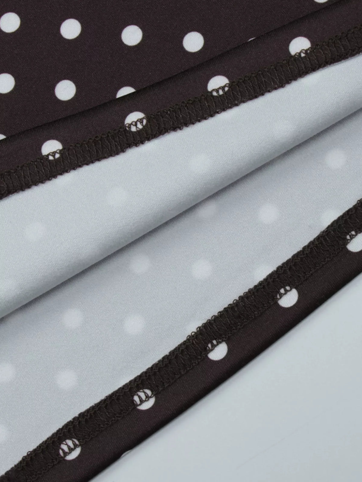 Polka dot cut-out front mini dress by Plush Fashion Hub, featuring a stylish design and playful polka dot pattern.