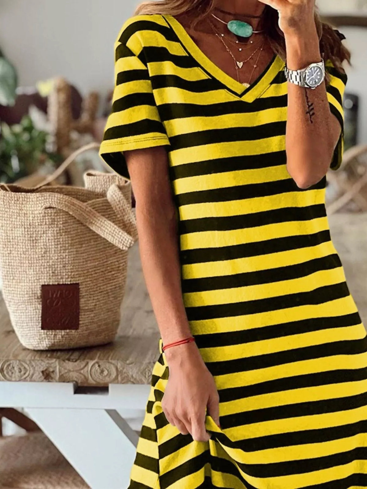 Plus size striped V-neck midi dress with side slit by Trendsi, showcasing relaxed fit and stylish design in the image.