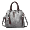 Ladies luxury handbag with soft material, spacious interior, zipper closure, and adjustable strap.