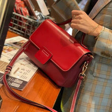  Leather handbag with retro vibe and contrast color on table.