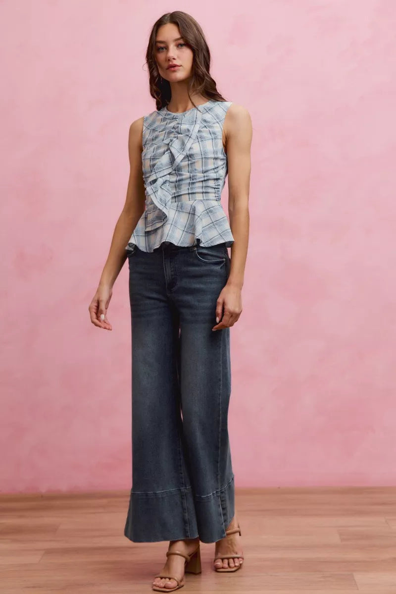 Plaid sleeveless ruffle peplum top by Plush Fashion Hub, featuring a stylish pattern and feminine ruffle details.