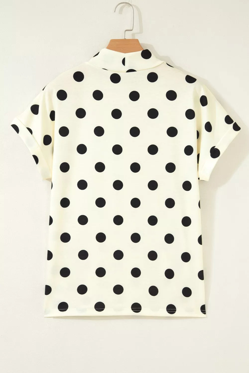 Polka dot print high neck dolman top from Trendsi, featuring a relaxed fit and stylish design, shown in the product image.