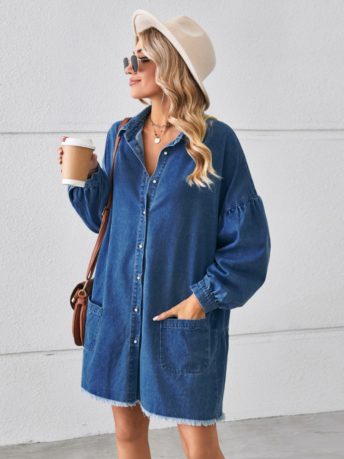 Button-up denim dress with pockets and raw hem from Plush Fashion Hub, featuring a casual, stylish fit and classic blue denim fabric.
