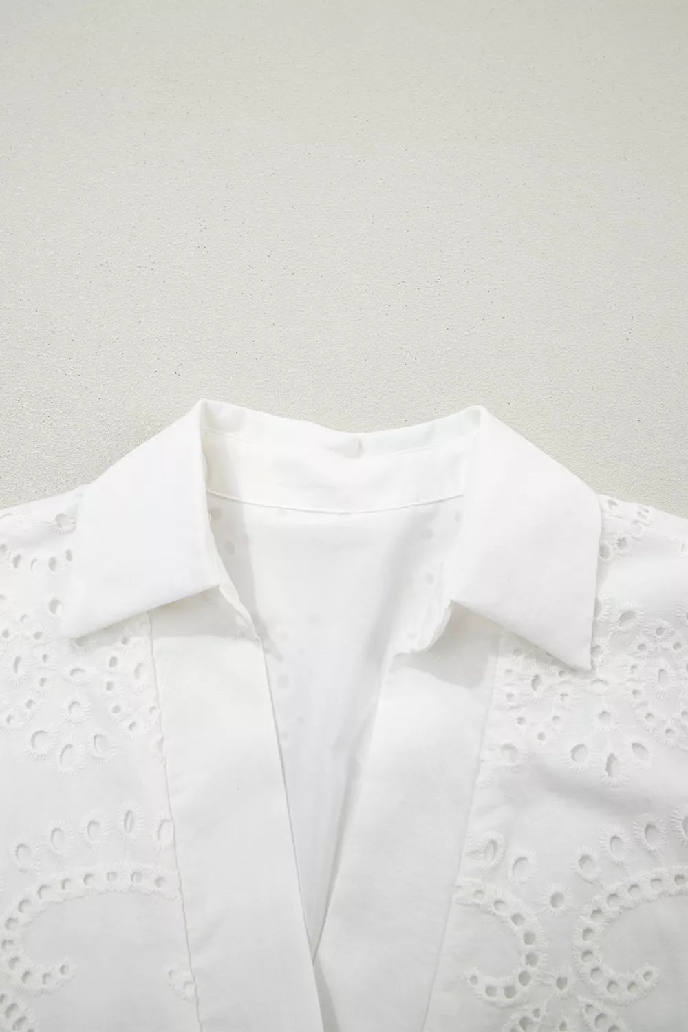 Solid color eyelet embroidered T-shirt mini dress by Plush Fashion Hub, featuring eyelet details and embroidered accents.