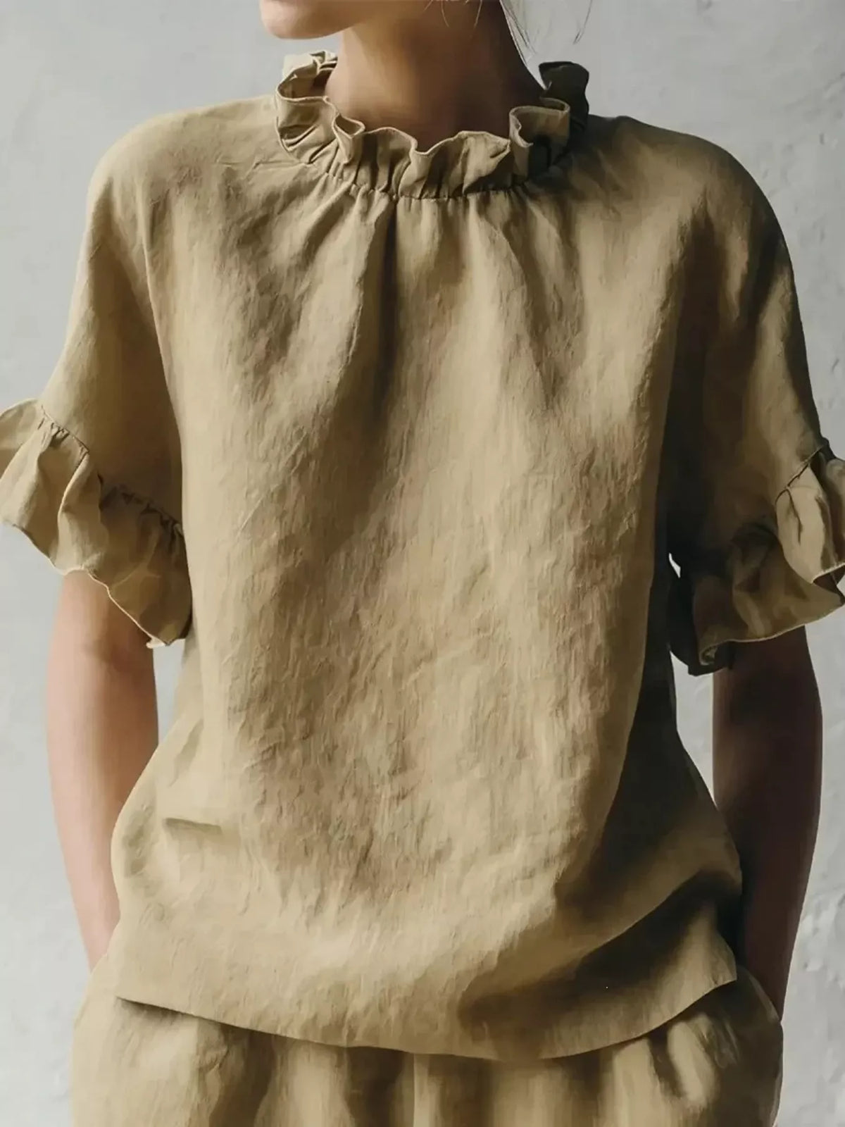 Plus size ruffled neck blouse with half sleeves from Plush Fashion Hub, featuring a full-size fit and elegant ruffle details.