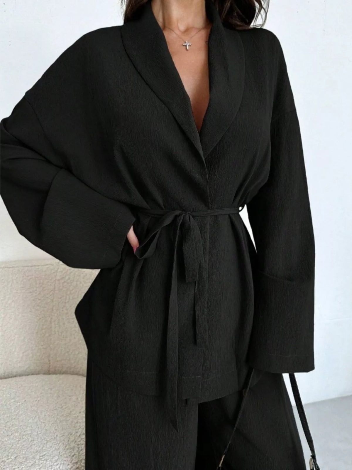 Textured tie waist top and wide-leg pants set for women by Trendsi, featuring a stylish, coordinated outfit with a modern silhouette.