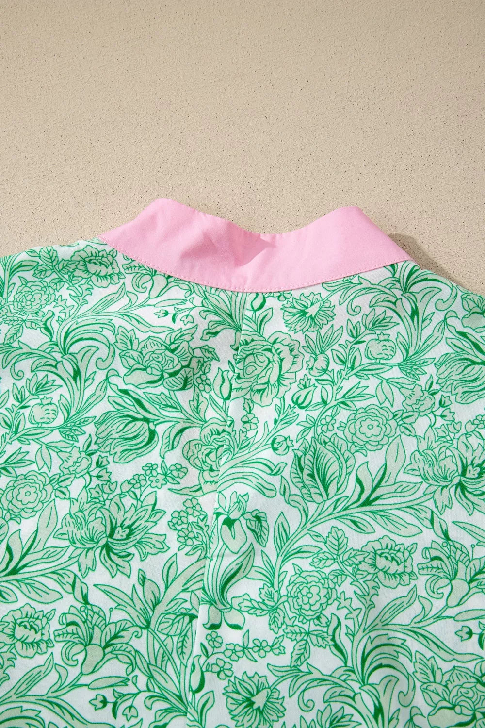 Floral midi dress with flutter sleeves and contrast trim from Trendsi, featuring a feminine, flowy design.