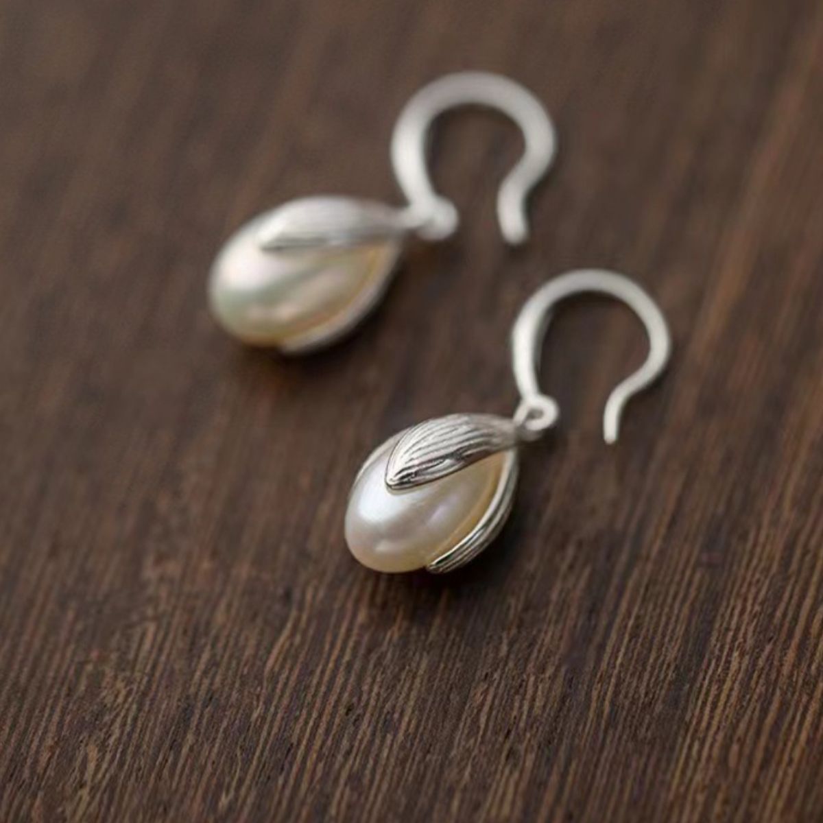 Sterling silver drop earrings featuring elegant design, crafted by Plush Fashion Hub, showcasing shiny silver hooks and decorative dangles.