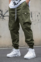 Men’s multi-pocket drawstring cargo pants from FitiqueFit, streetwear style, featuring multiple cargo pockets and adjustable drawstring waist.