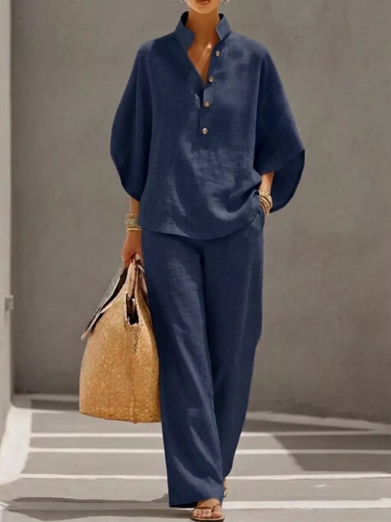 Women's plus size two-piece dress set with button-detail 3/4 sleeves and matching pants by Trendsi, shown on a model.
