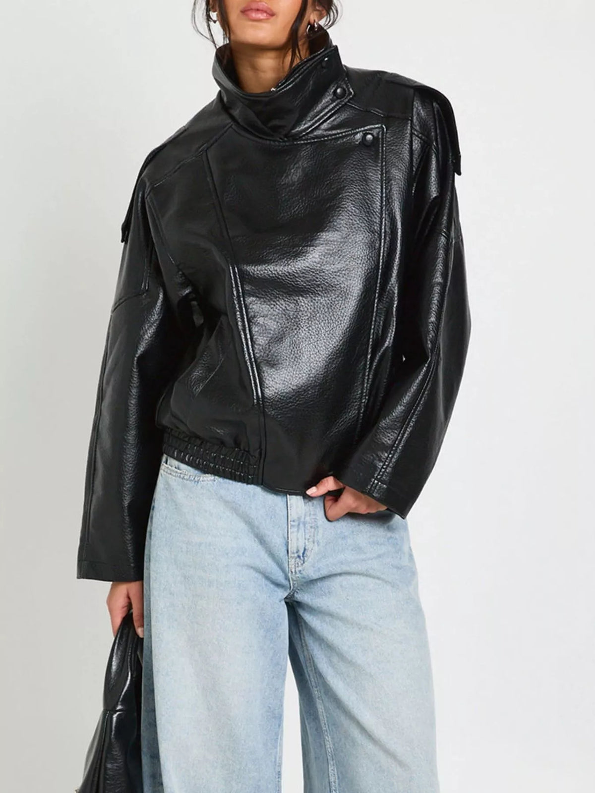 Women's faux leather moto jacket with asymmetrical zip, stylish and fitted, by Trendsi, shown in black with front zipper detail.