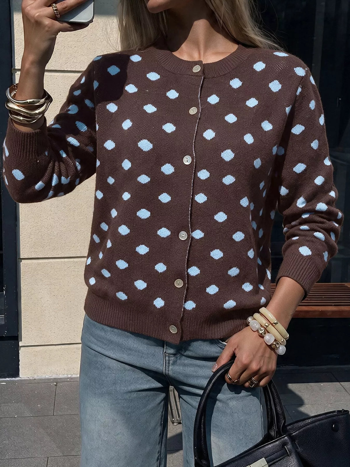 Women’s polka dot button-up cardigan by Trendsi, featuring a soft knit fabric, classic polka dot pattern, and front button closure.