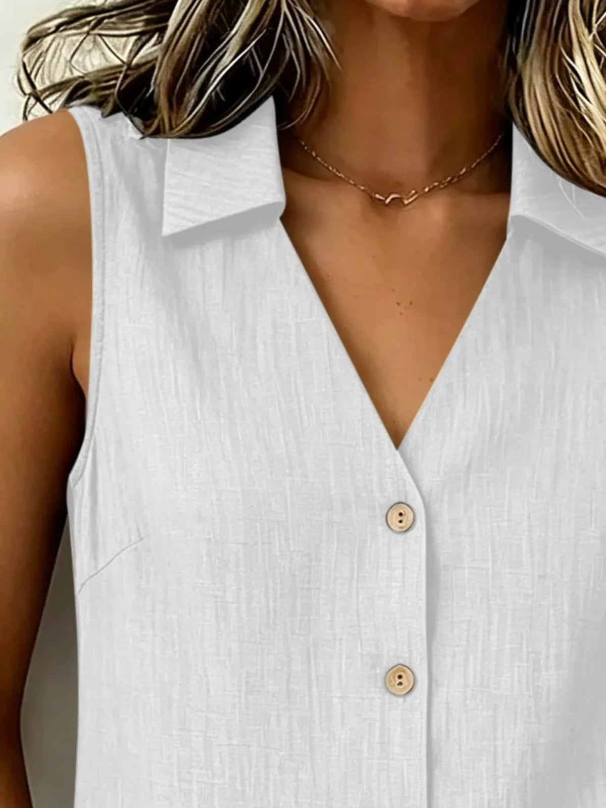 Plus size sleeveless button-up collared top from Trendsi, featuring a stylish full button front and sleeveless design.