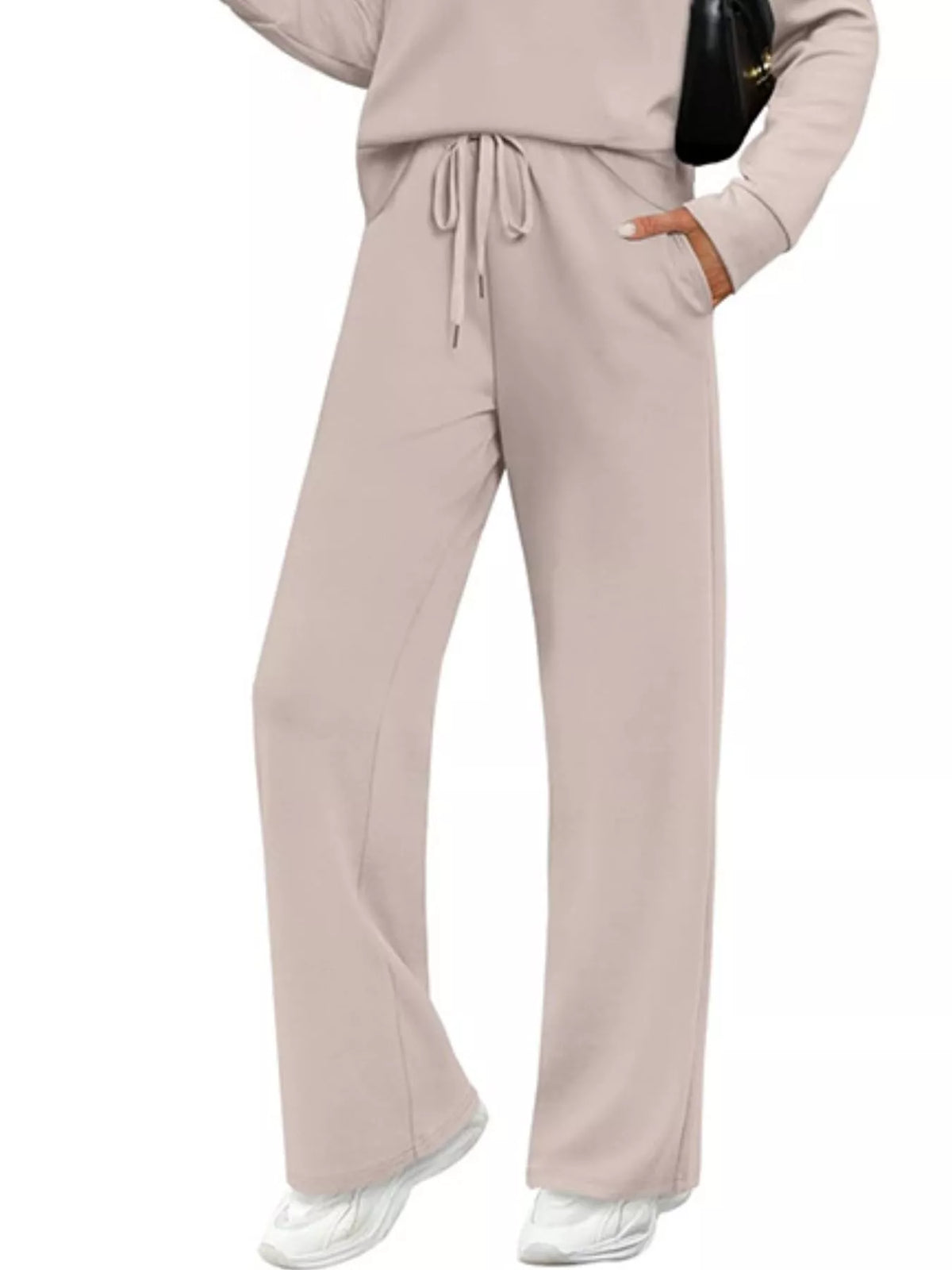 Plus size casual long sleeve crewneck top and drawstring pants set by Trendsi, featuring comfortable fabric and relaxed fit.