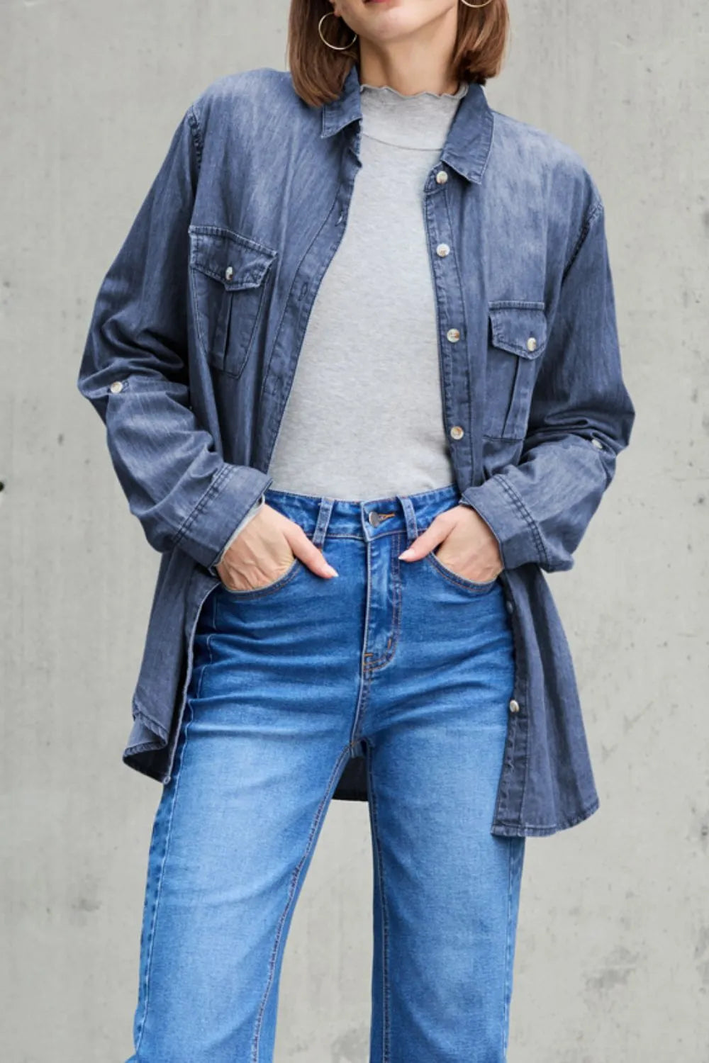 Denim top with long sleeves, collared neck, and front pockets in classic blue denim, styled by Trendsi.