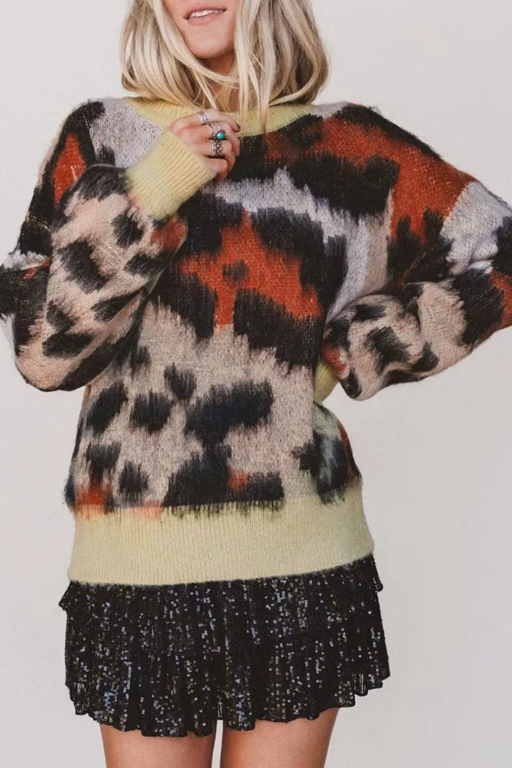 Leopard print drop shoulder long sleeve sweater with round neck from Trendsi, featuring a soft knit fabric and relaxed fit.