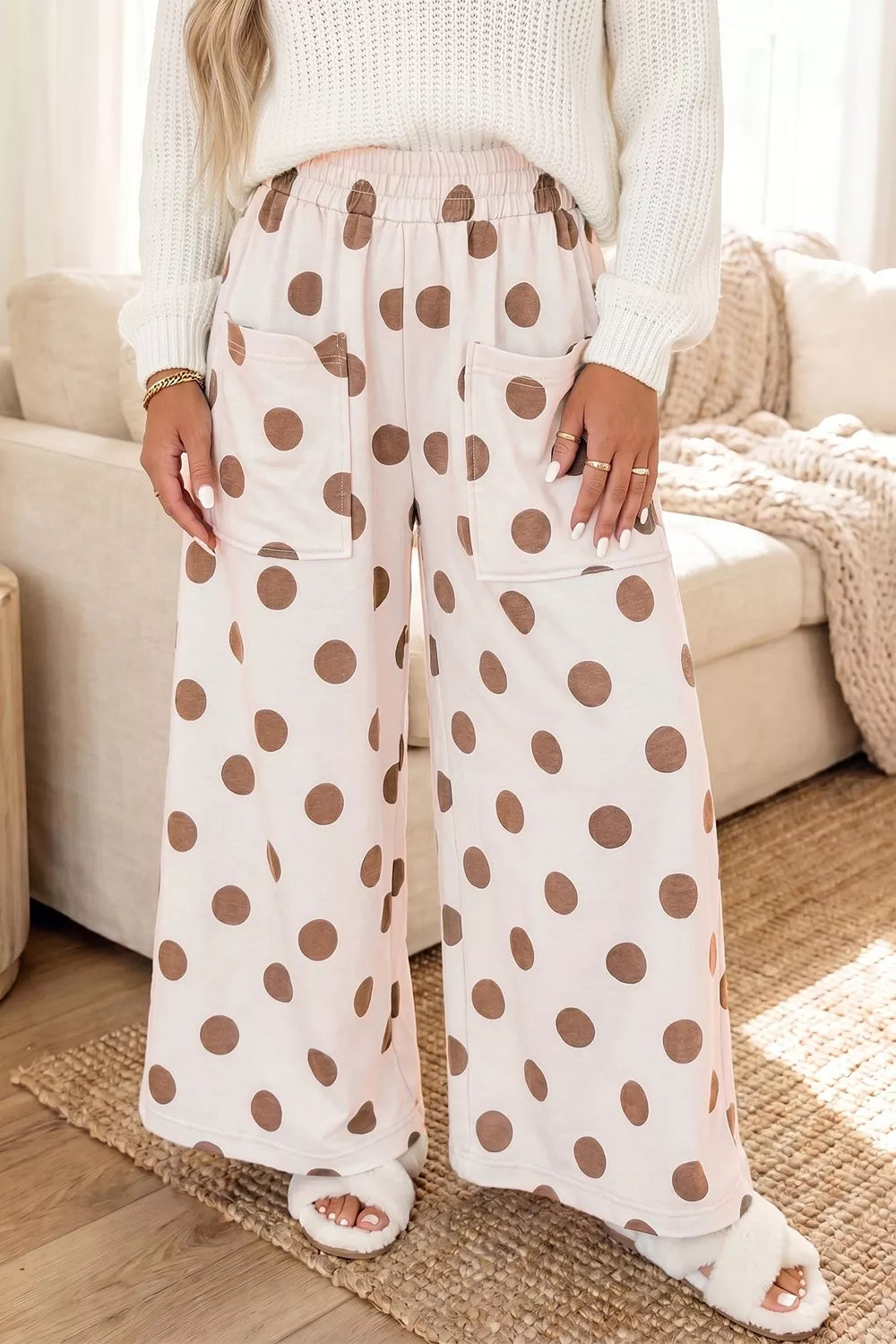 Polka dot wide-leg casual pants with elastic waist by Trendsi, featuring a relaxed fit and playful black and white pattern.