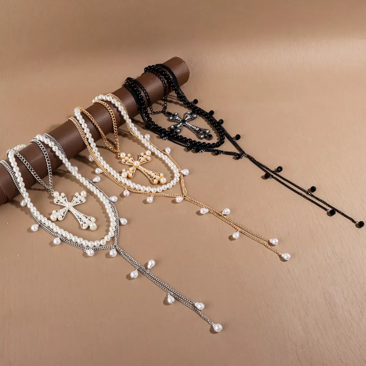 Three-piece set of pearl cross pendant necklaces by Plush Fashion Hub featuring elegant jewelry with pearl and cross designs.
