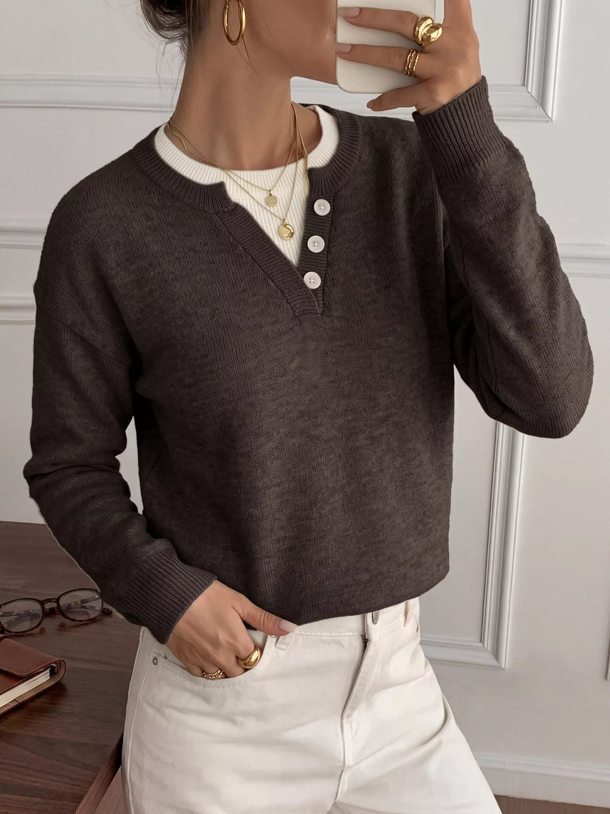Ribbed knit sweater with decorative button placket in a neutral color, featuring a cozy, fitted design from Trendsi.