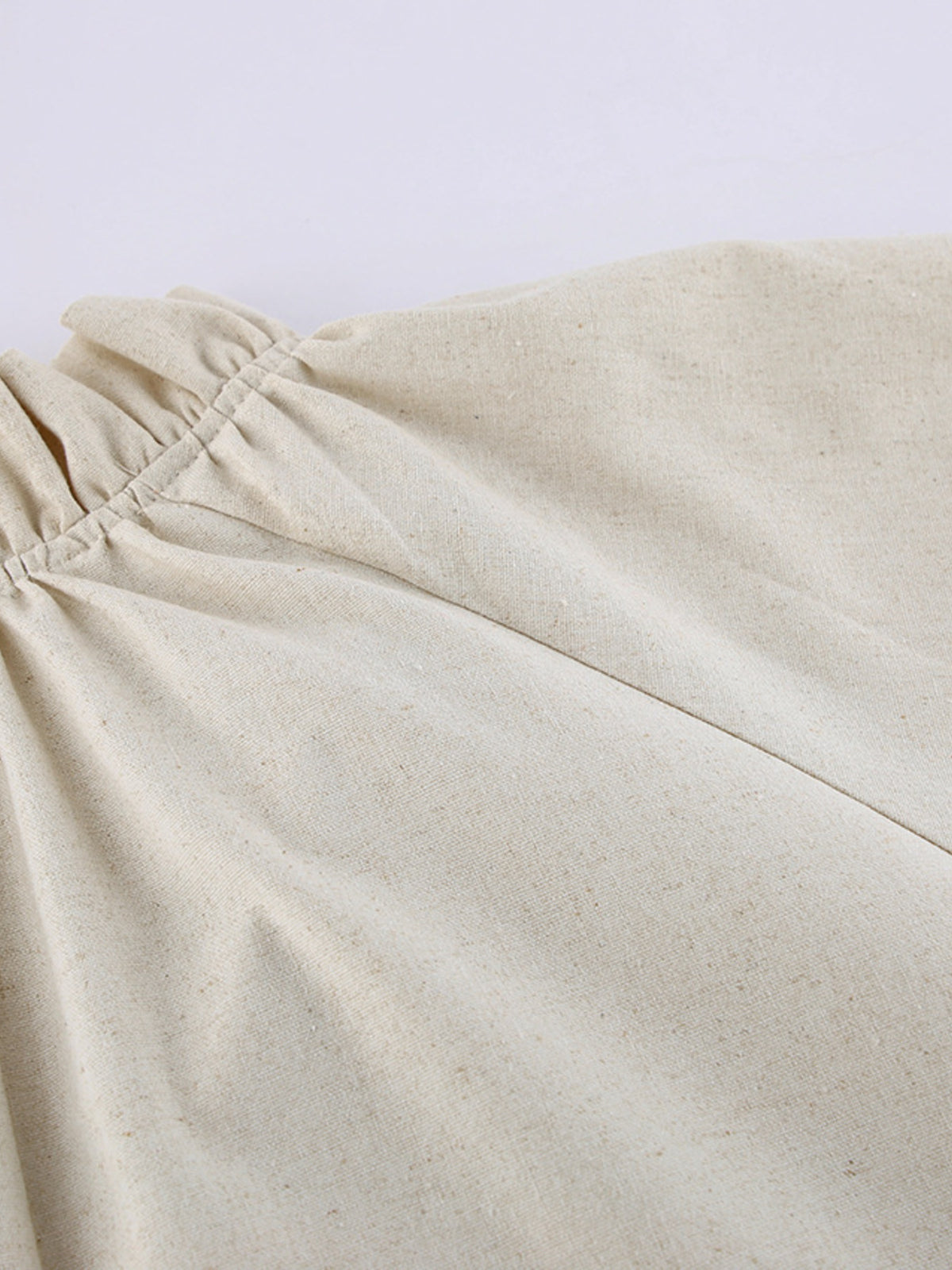 Cotton linen maxi dress by Plush Fashion Hub with tie neckline and flounce sleeves, shown on a model in a bright, airy setting.