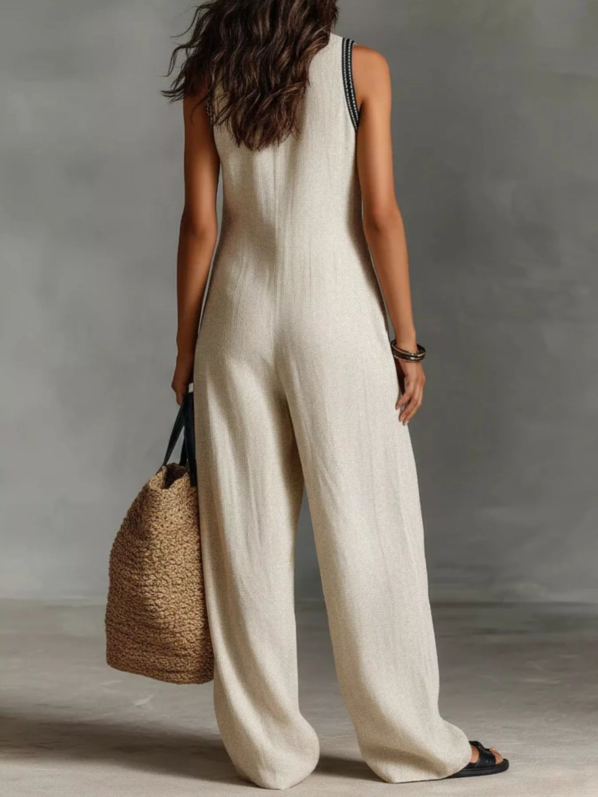 Plus size full length sleeveless wide-leg jumpsuit from Trendsi, showcasing a stylish, flowy silhouette and sleeveless design.