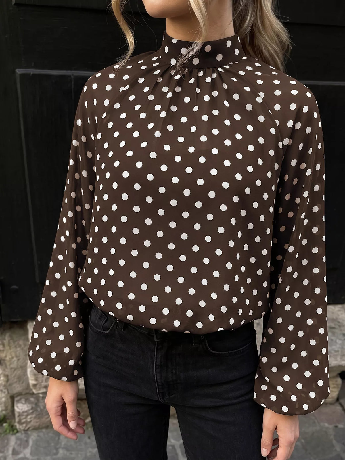 Polka dot mock neck long sleeve blouse by Trendsi featuring a classic pattern and fitted design, shown on a mannequin.