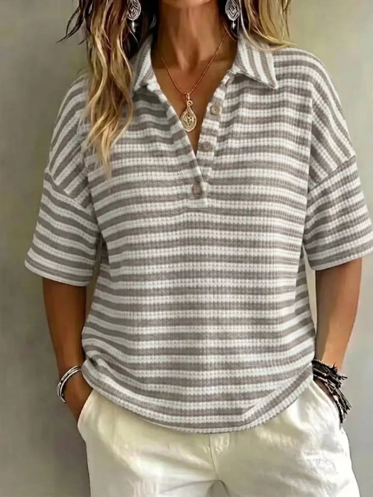Plus size contrast striped knit polo shirt for women, trendy full-coverage top with bold stripe pattern and classic collar.