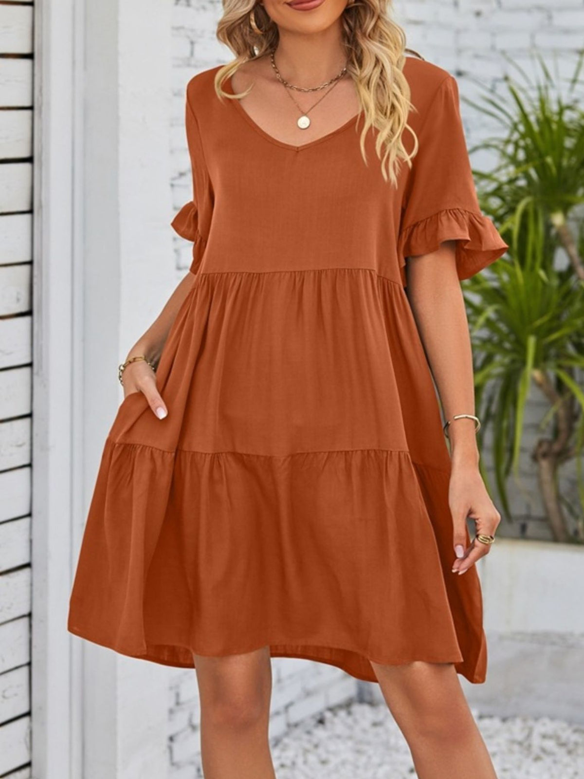 Lightweight rayon ruffled sleeve tiered mini dress with pockets by Plush Fashion Hub, showcasing its flowy fabric and stylish design.