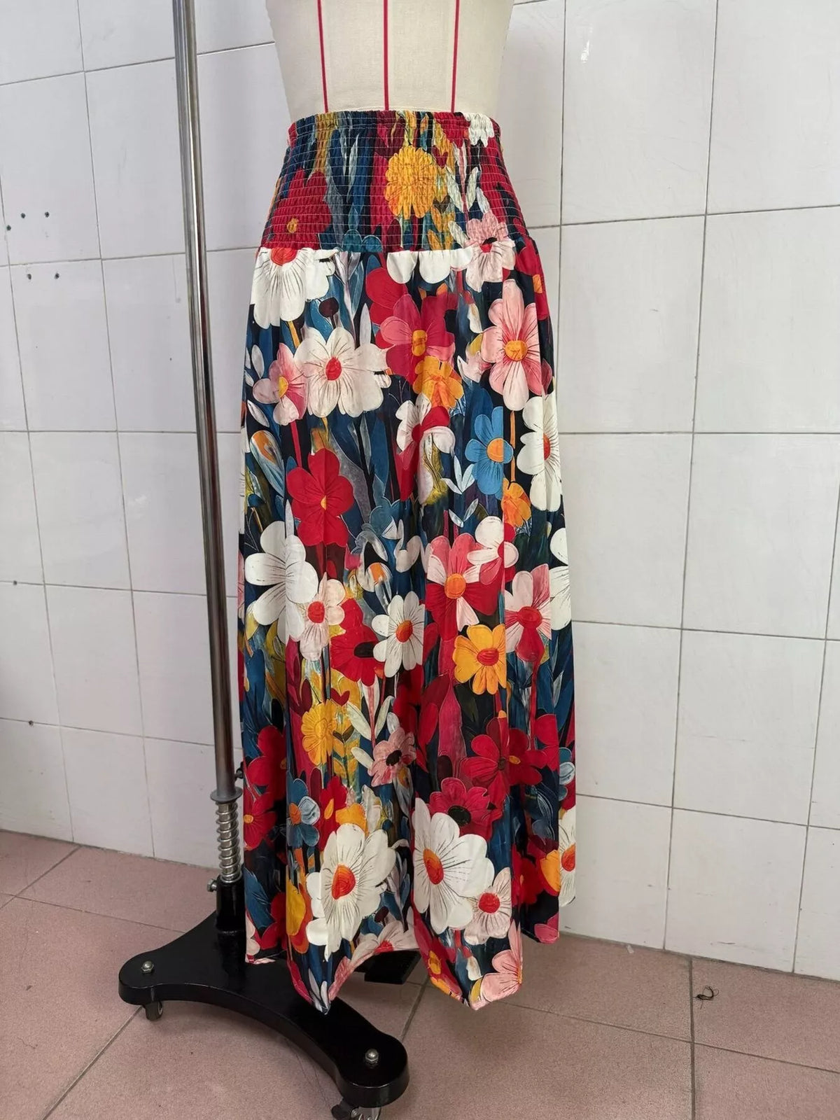 Floral print high-waisted maxi skirt from Trendsi, flowing fabric with vibrant flower patterns and a comfortable waist design.