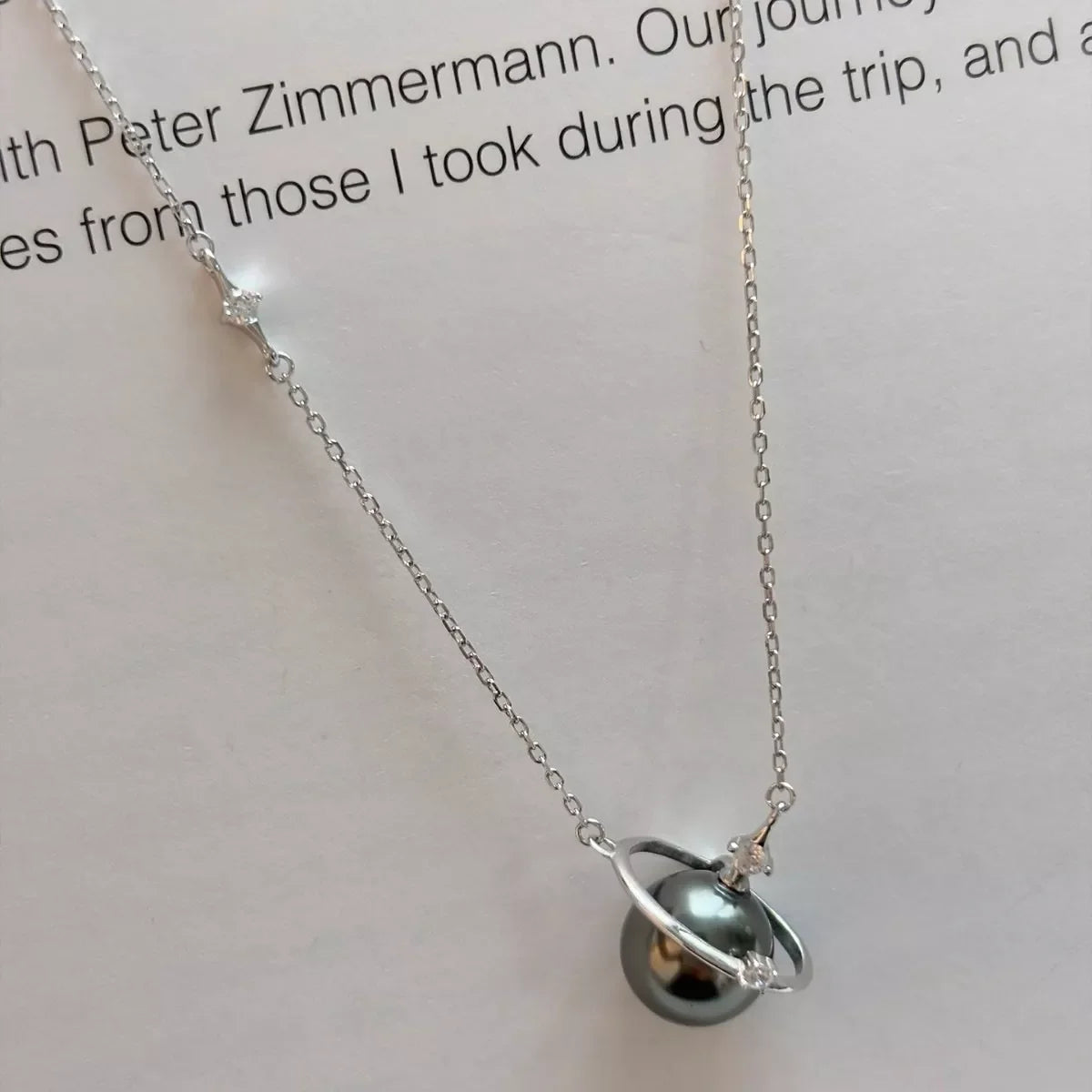 Plush Fashion Hub Planet Pearl pendant necklace featuring a shimmering pearl pendant on a delicate chain.