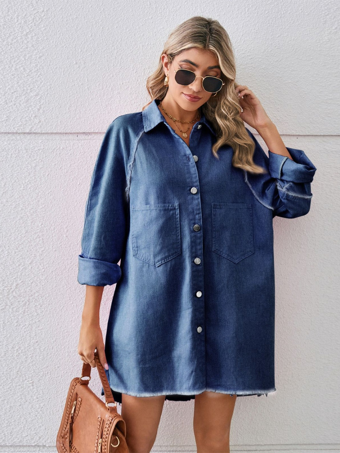 Raw hem button-up denim dress by Plush Fashion Hub displayed on a model, featuring a casual style with front buttons and raw hem details.