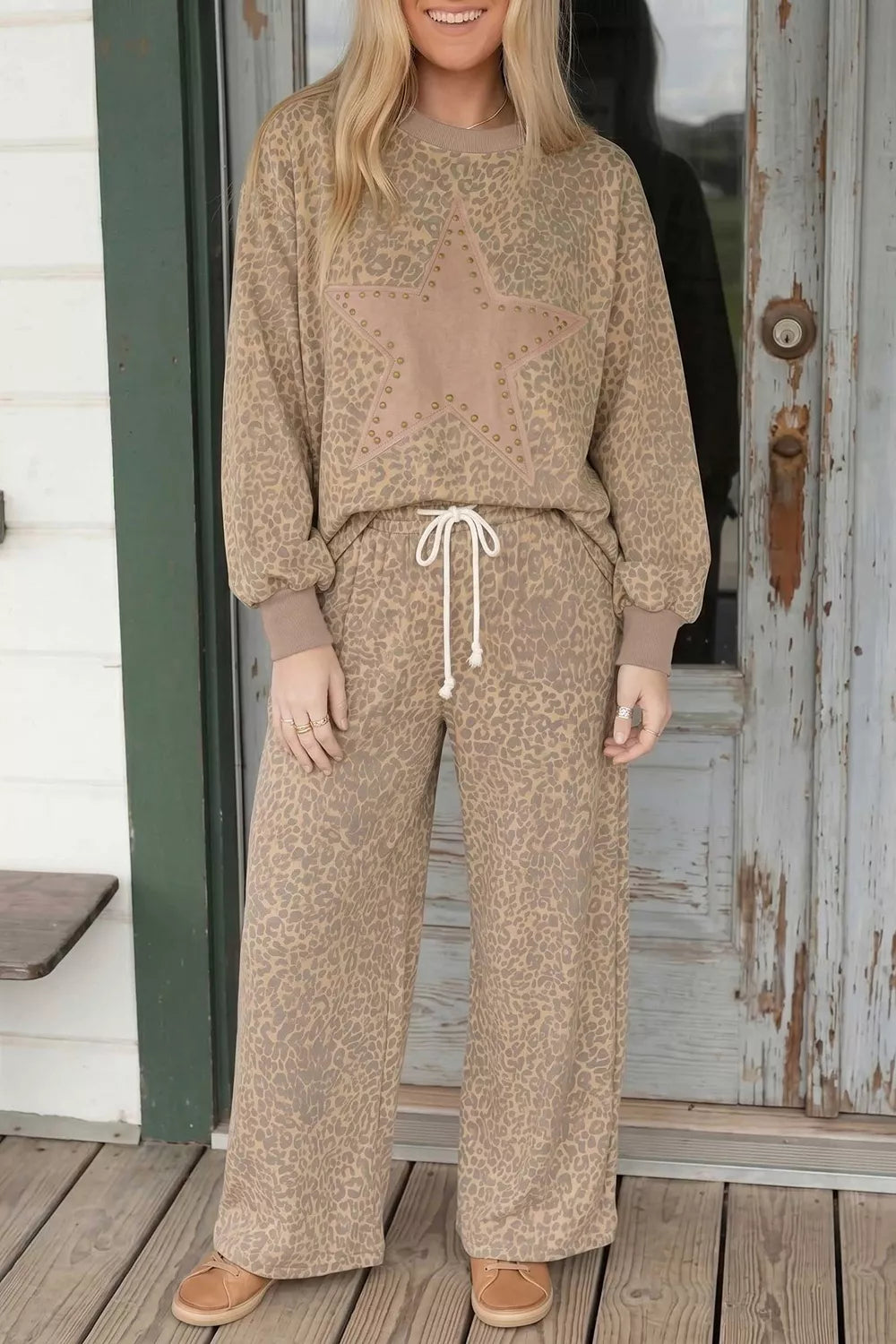 Leopard print star-embellished sweatshirt and pants set by Trendsi, featuring a cozy matching design with star details.