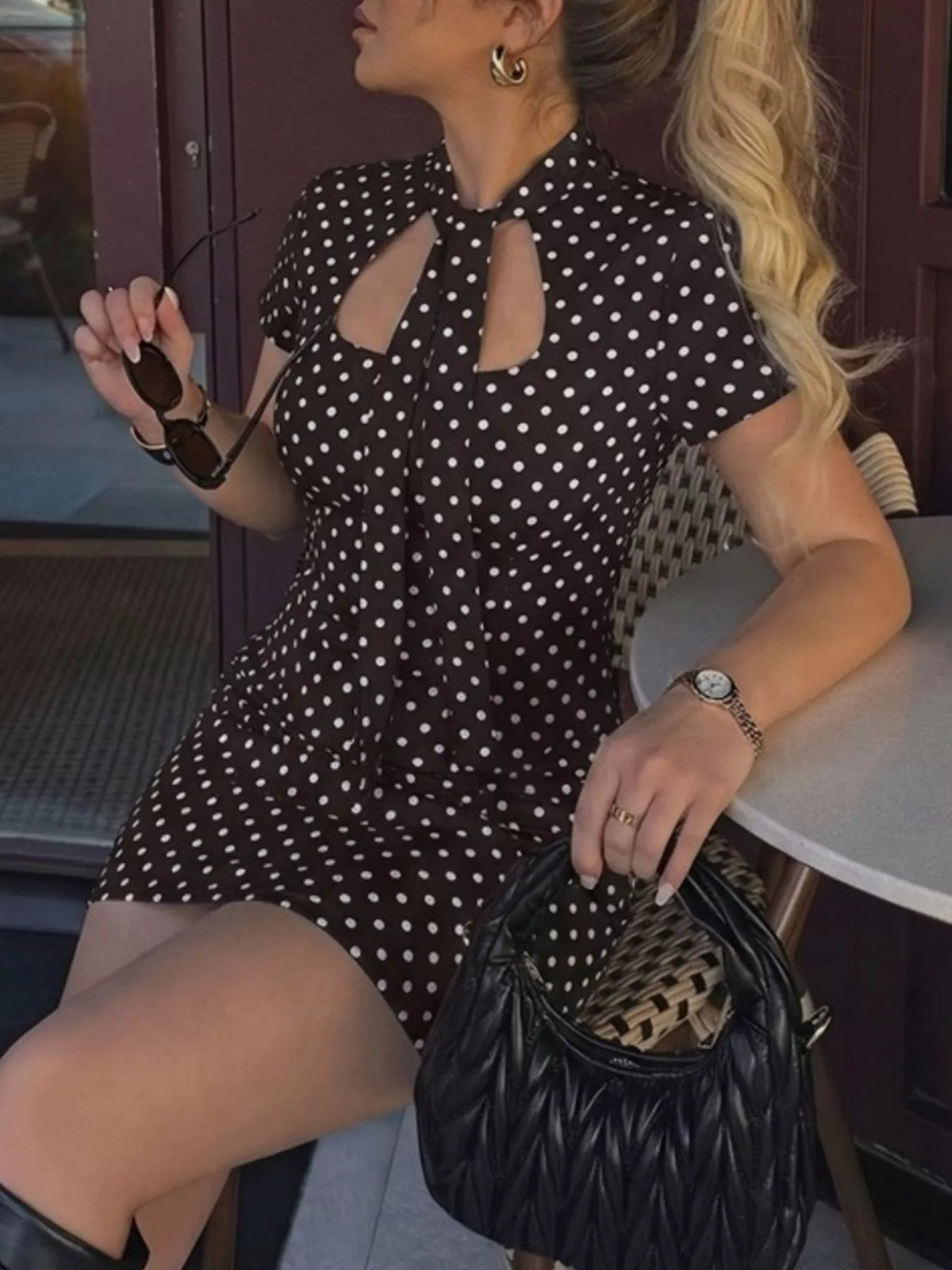 Polka dot cut-out front mini dress by Plush Fashion Hub featuring a fitted silhouette and stylish design.