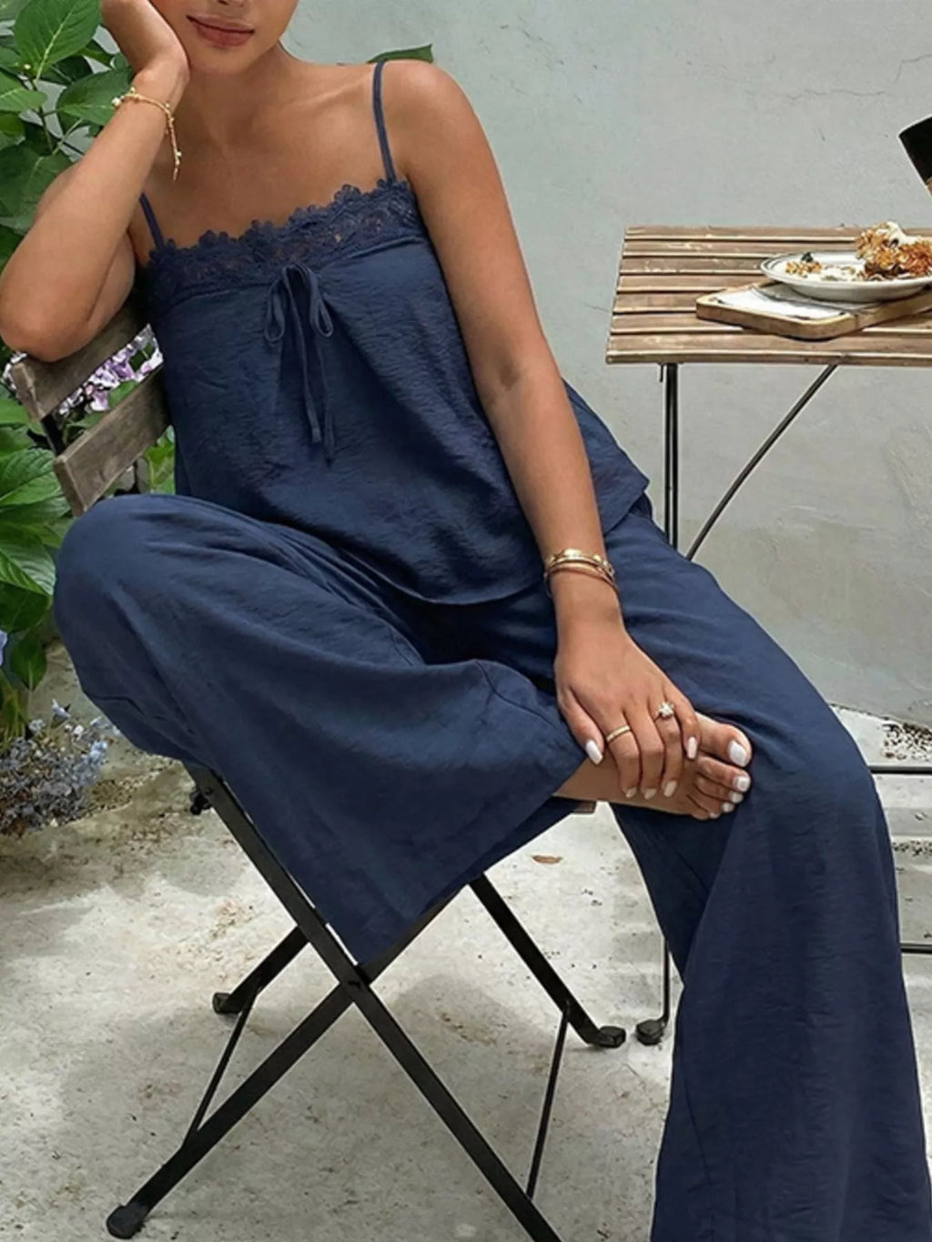 Lace trim cami and wide-leg pants matching set by Trendsi, featuring a stylish camisole with lace details and flowy pants.