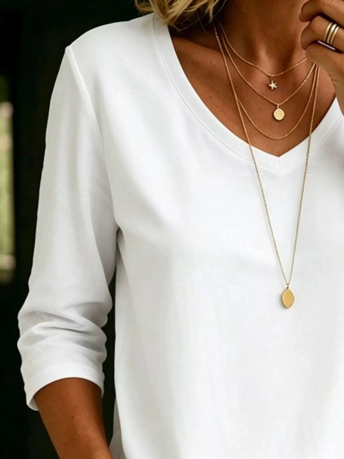 Plus size Trendsi full size v-neck 3/4 sleeve t-shirt top, casual style with a relaxed fit and soft fabric, displayed on a hanger.