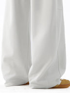 Men's wide-leg casual drawstring pants with relaxed fit, black trousers from Trendsi, displayed flat on a white background.