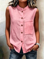 Women's sleeveless crop top by FitiqueFit featuring buttoned pockets, solid color casualwear, shown in a water-themed setting.