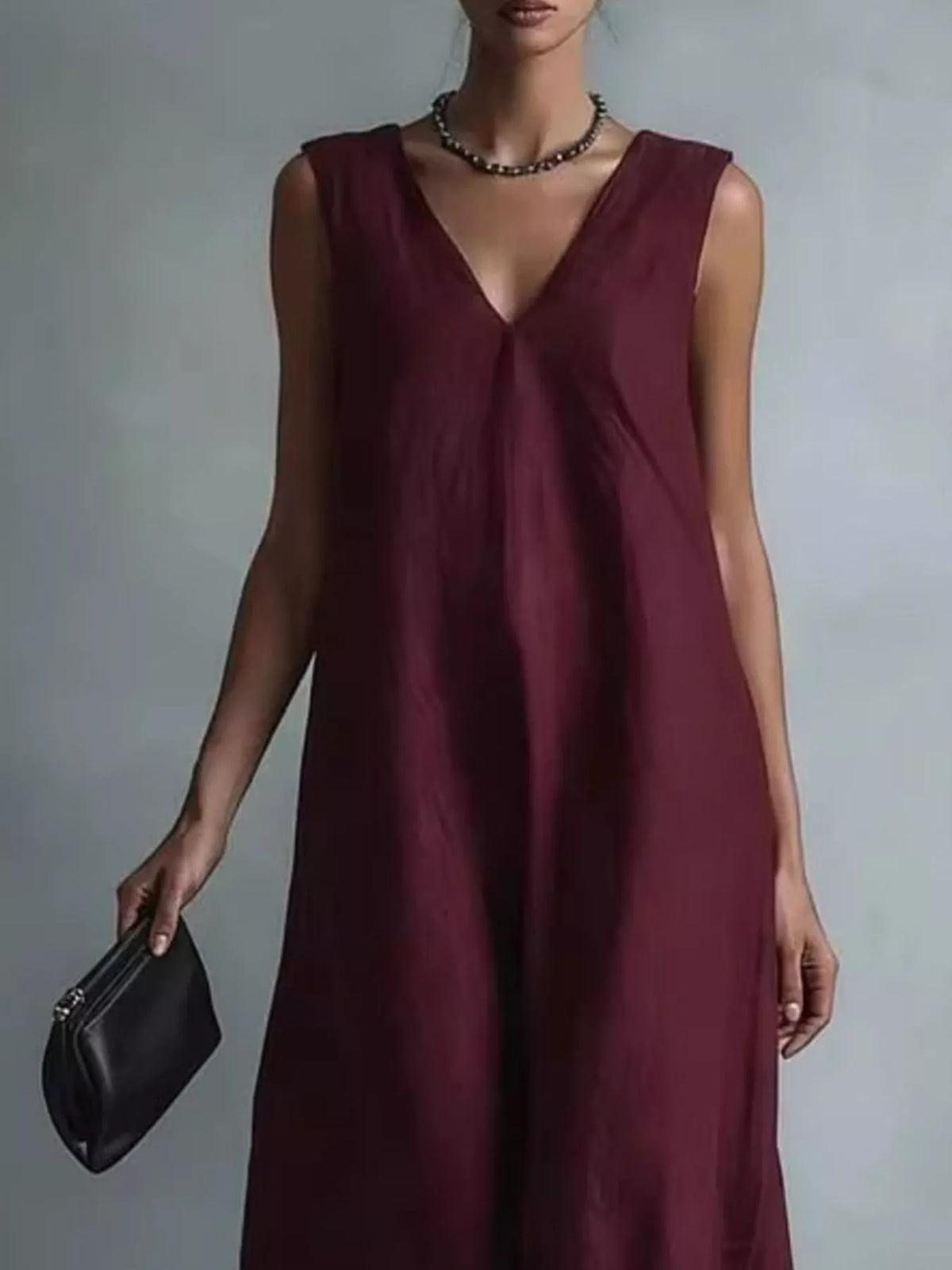 Plus size full V-neck sleeveless maxi dress from Plush Fashion Hub, flowing fabric with a relaxed fit and elegant design.