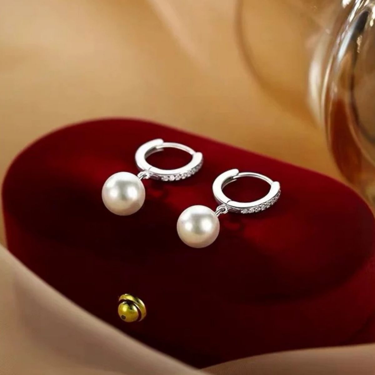 Pearl drop hoop earrings by Plush Fashion Hub featuring elegant white pearls and gold-tone hoops on a white background.