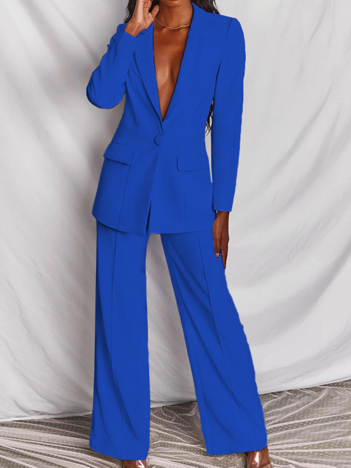 Plus size blazer and wide-leg pants matching set by Trendsi, featuring a one-button blazer and stylish wide-leg trousers.