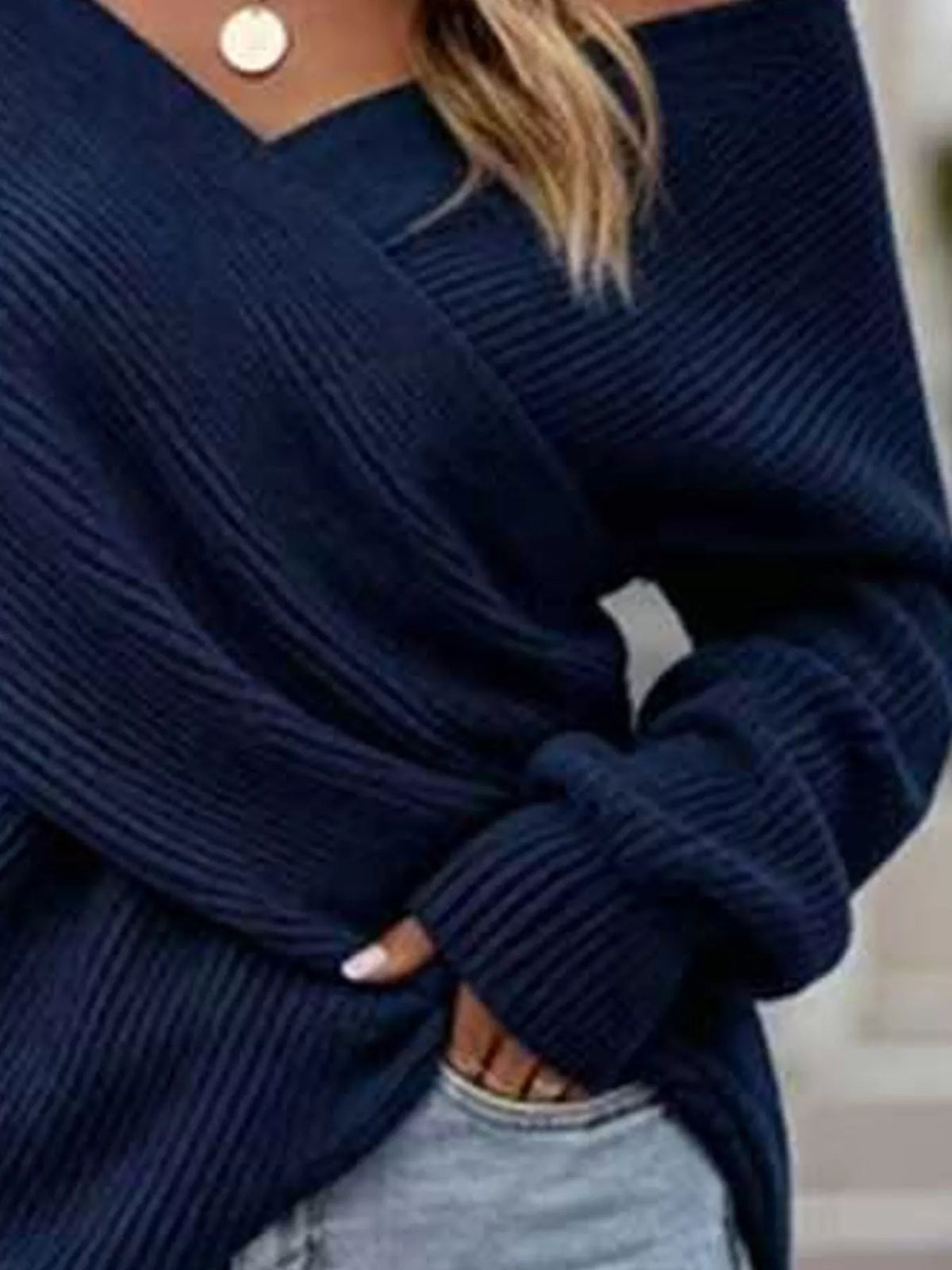 Crisscross ribbed knit long sleeve sweater by Trendsi, featuring a fitted design and textured ribbed pattern.