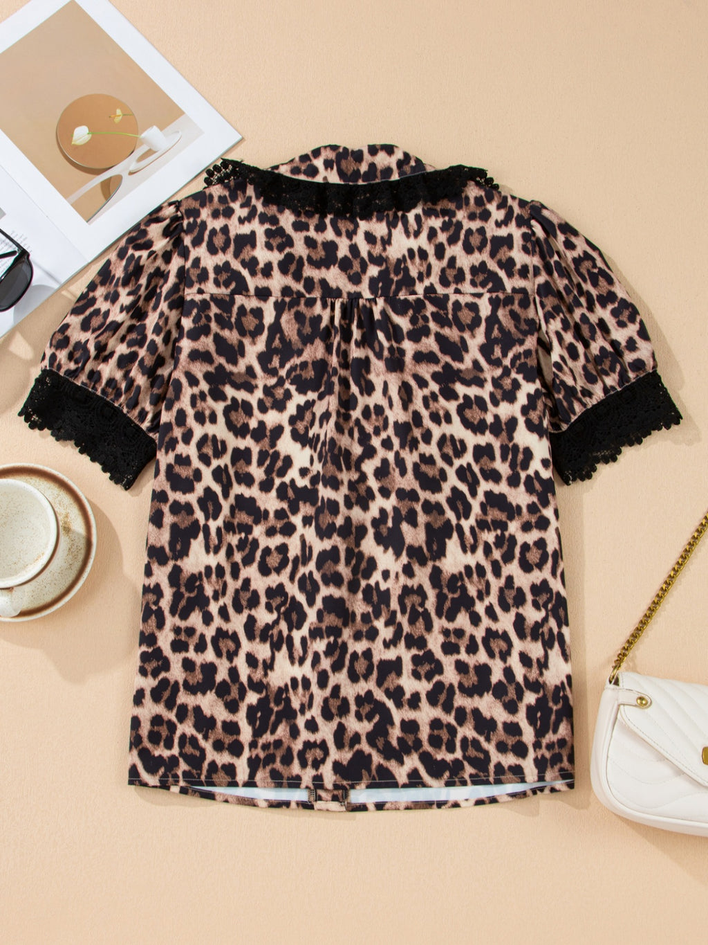 Leopard print short sleeve blouse with lace trim and button front, stylish women's top by Trendsi.