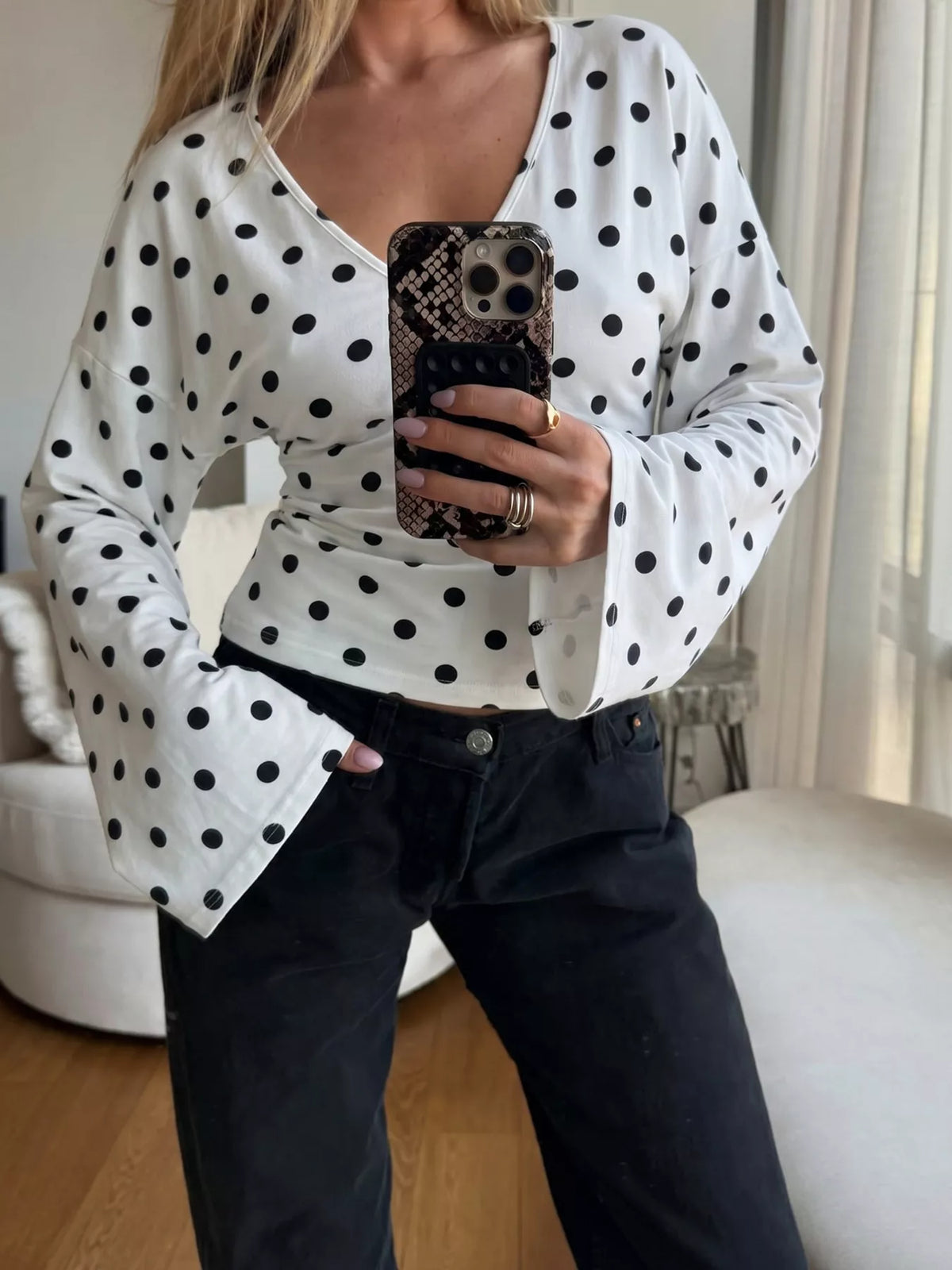 Polka dot V-neck long sleeve T-shirt by Plush Fashion Hub, featuring a stylish pattern and comfortable fit.