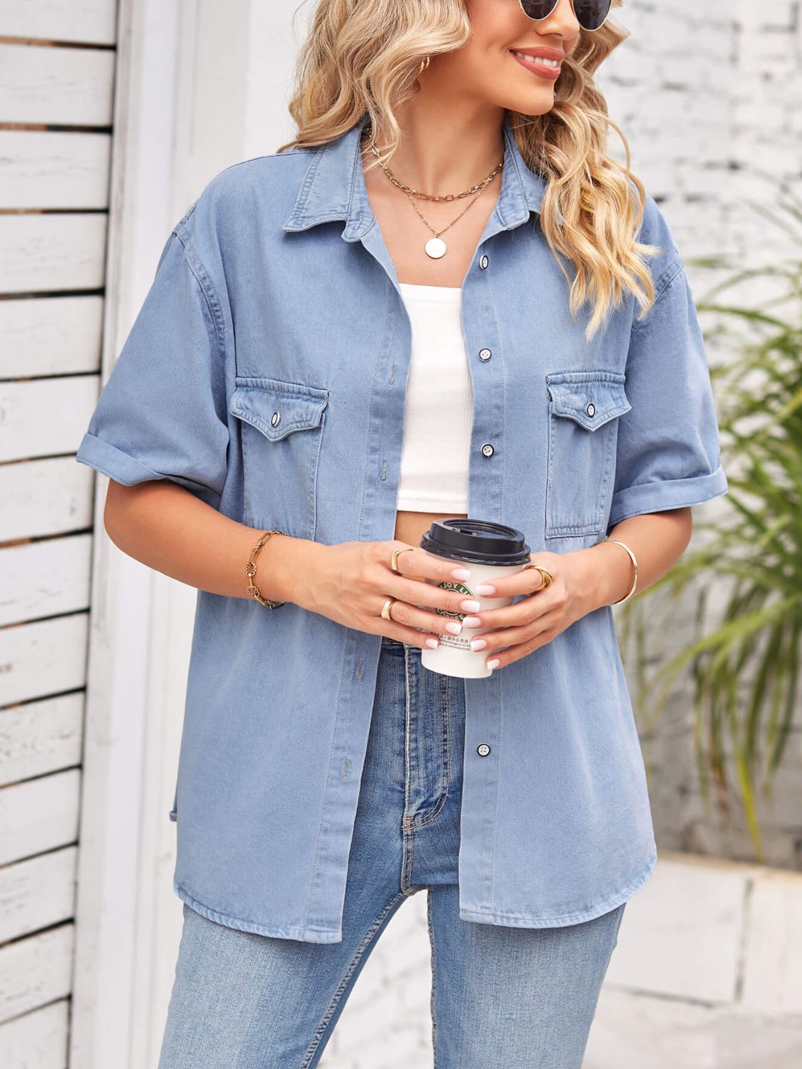 Denim short sleeve collared jacket by Plush Fashion Hub featuring classic design and button closure, hanging on a wooden hanger.