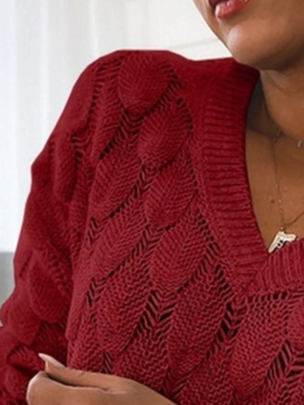 V-neck knitted sweater from Trendsi featuring a cozy, stylish design with long sleeves and ribbed cuffs, ideal for casual wear.